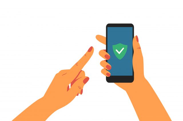 Human hand holding mobile phone with green shield at the screen.