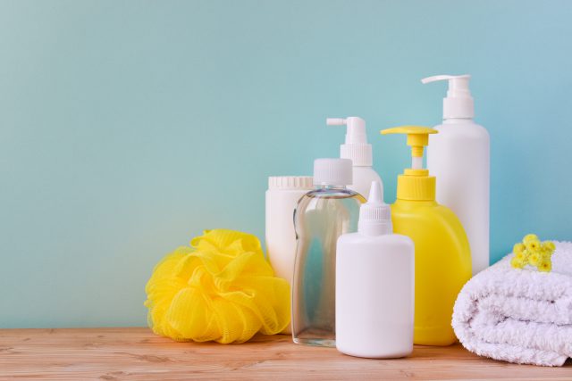 A vessel with body care products, a roll of towels and a washcloth. Spa Relax Baby hygiene.
